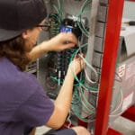 Person working on installing wiring in a light fixture